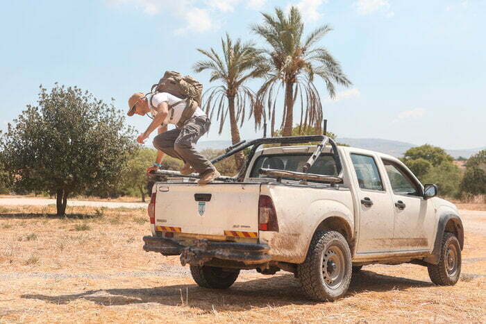 Man Jumping Off Van With A Source Backpack