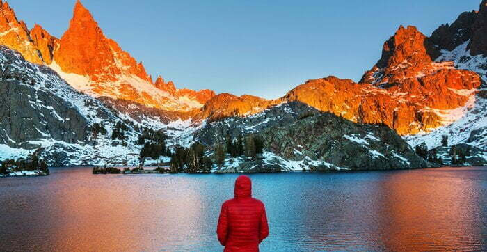 man looking at the mountains in the winter