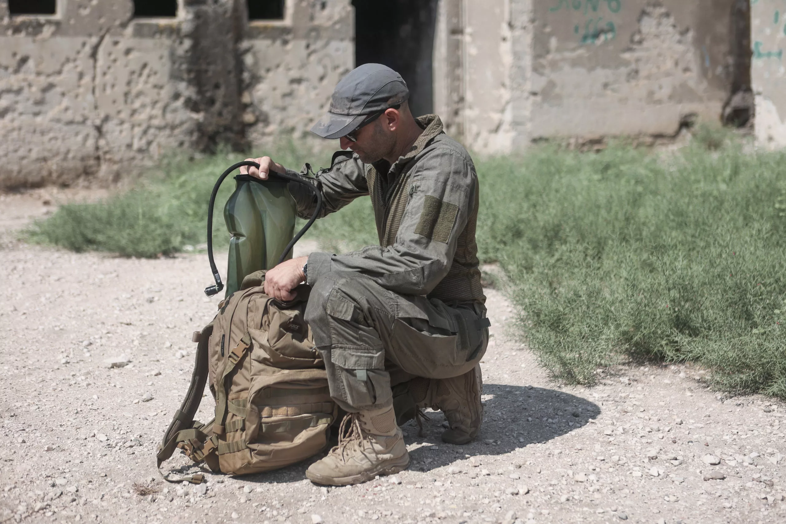 soldier putting hydration pack back in military rucksack